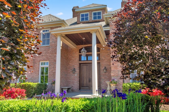 27 True Harbour Way W, Islip, NY 11795 - view of exterior entry featuring brick siding and a chimney