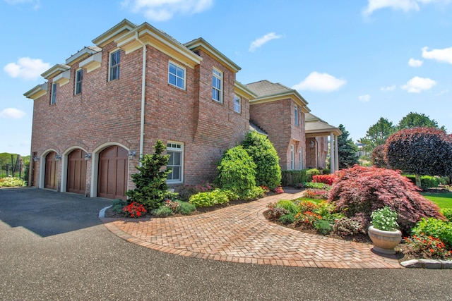 27 True Harbour Way W, Islip, NY 11795 - view of side of property with an attached garage, driveway, and brick siding