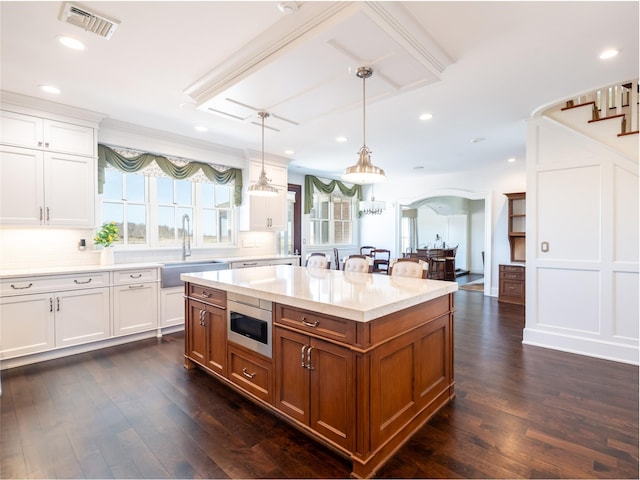 27 True Harbour Way W, Islip, NY 11795 - kitchen with a sink, brown cabinetry, decorative light fixtures, white cabinetry, and tasteful backsplash