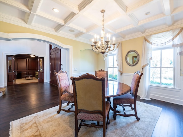 27 True Harbour Way W, Islip, NY 11795 - dining space featuring coffered ceiling, a chandelier, dark wood finished floors, crown molding, and a wainscoted wall