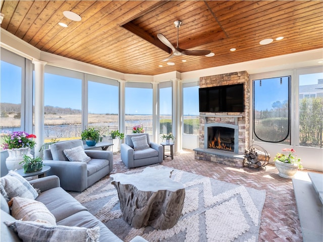 27 True Harbour Way W, Islip, NY 11795 - living area with wood ceiling, brick flooring, a ceiling fan, a fireplace, and recessed lighting