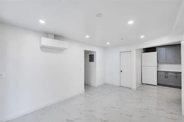 324 Ralph Ave, Brooklyn, NY 11233 - below grade area featuring freestanding refrigerator, a wall mounted AC, recessed lighting, and light marble finish flooring