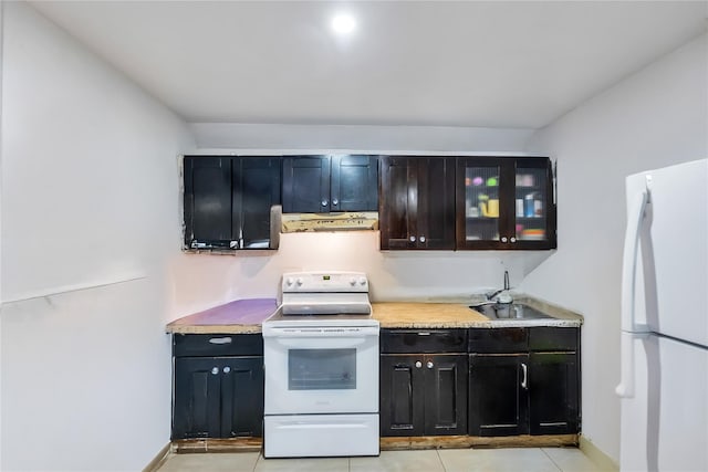 324 Ralph Ave, Brooklyn, NY 11233 - kitchen with white appliances, under cabinet range hood, light tile patterned flooring, and light countertops