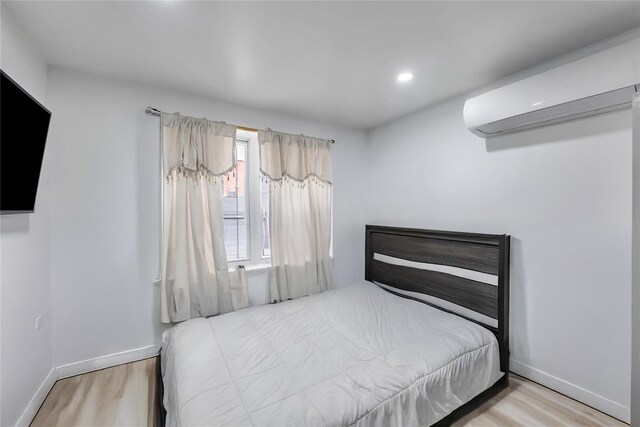324 Ralph Ave, Brooklyn, NY 11233 - bedroom with wood finished floors, a wall unit AC, and recessed lighting