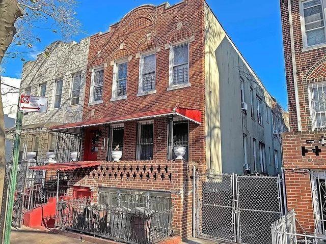 multi unit property featuring fence and brick siding