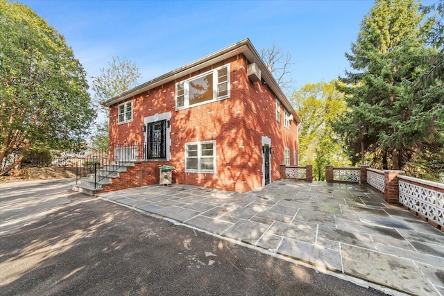 10 Mohawk Rd, Yonkers, NY 10710 - rear view of property featuring brick siding and a wall mounted air conditioner