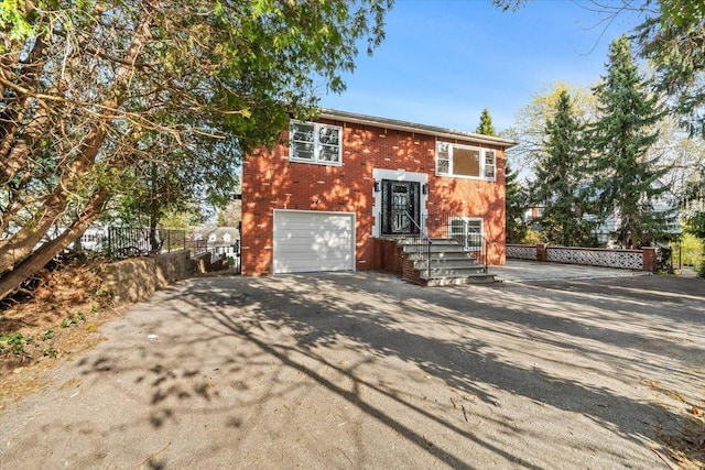 10 Mohawk Rd, Yonkers, NY 10710 - bi-level home featuring fence, driveway, brick siding, and a garage