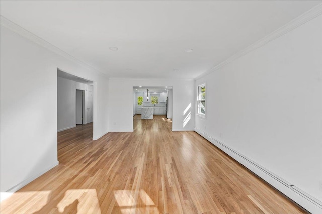 10 Mohawk Rd, Yonkers, NY 10710 - unfurnished living room featuring a baseboard heating unit, baseboards, light wood-style floors, and crown molding