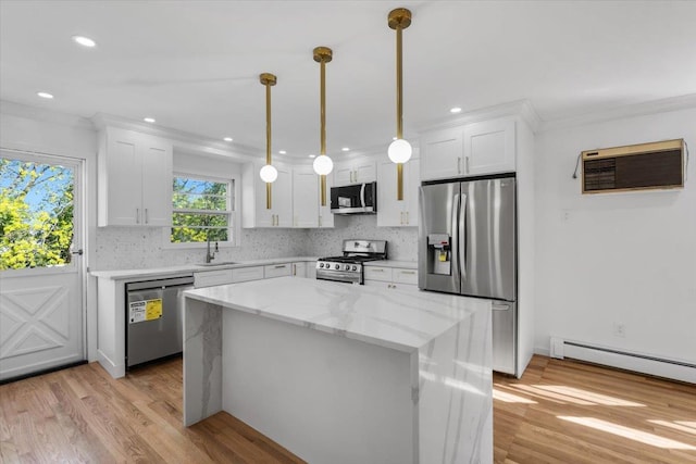 10 Mohawk Rd, Yonkers, NY 10710 - kitchen with crown molding, appliances with stainless steel finishes, white cabinetry, and a sink