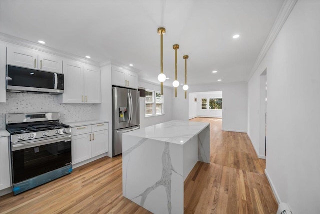 10 Mohawk Rd, Yonkers, NY 10710 - kitchen featuring white cabinets, stainless steel appliances, a center island, decorative backsplash, and ornamental molding