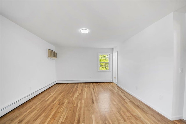 10 Mohawk Rd, Yonkers, NY 10710 - unfurnished room with a baseboard heating unit, a wall mounted AC, light wood-type flooring, and baseboards