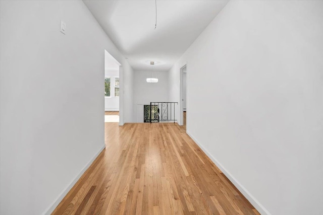 10 Mohawk Rd, Yonkers, NY 10710 - hall featuring a notable chandelier, an upstairs landing, baseboards, and light wood-style floors