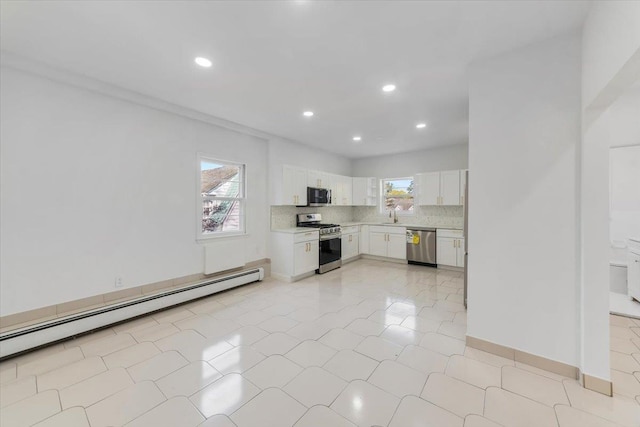 10 Mohawk Rd, Yonkers, NY 10710 - kitchen featuring a baseboard radiator, stainless steel appliances, light countertops, white cabinetry, and recessed lighting