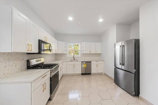 10 Mohawk Rd, Yonkers, NY 10710 - kitchen with recessed lighting, stainless steel appliances, a sink, tasteful backsplash, and white cabinetry