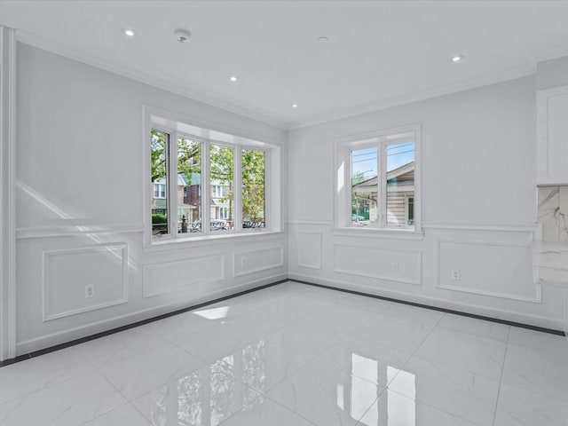 unfurnished room with crown molding, marble finish floor, and a decorative wall