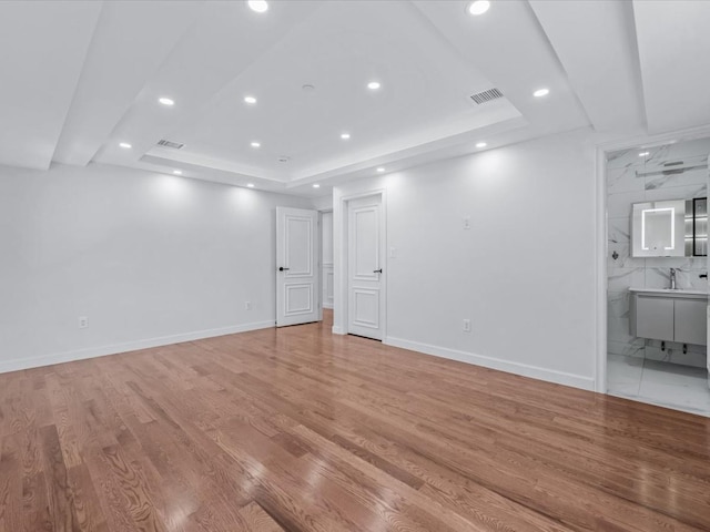 interior space with recessed lighting, light wood-style flooring, baseboards, and visible vents