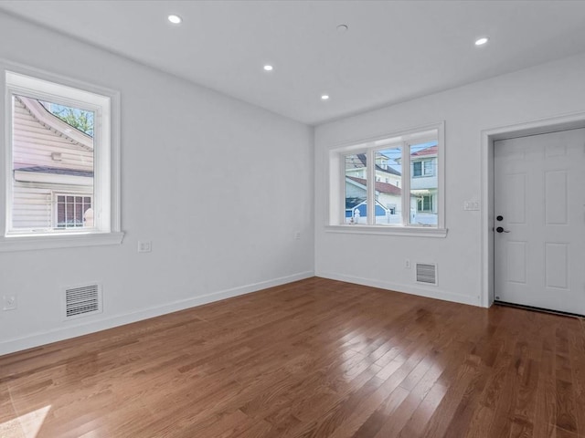 entryway featuring visible vents, wood finished floors, and a healthy amount of sunlight