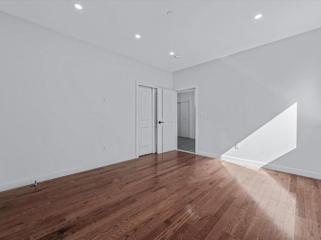 unfurnished room with recessed lighting, baseboards, and wood finished floors