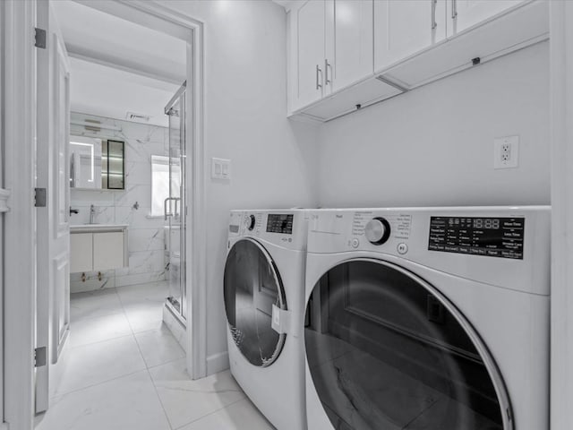 laundry area with cabinet space, visible vents, and washing machine and dryer