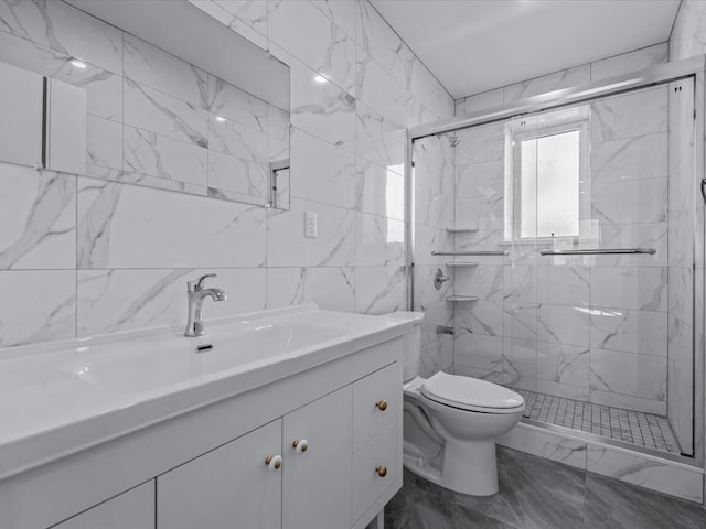 full bathroom featuring vanity, marble finish floor, toilet, tile walls, and a marble finish shower