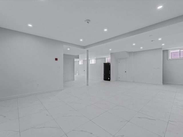 unfurnished room with baseboards and recessed lighting