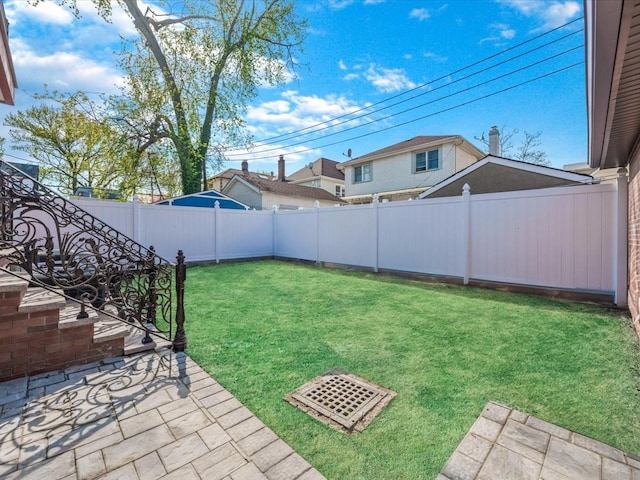 view of yard with a fenced backyard