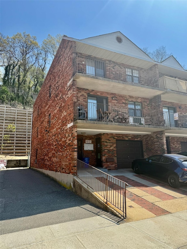 view of property with a garage and aphalt driveway
