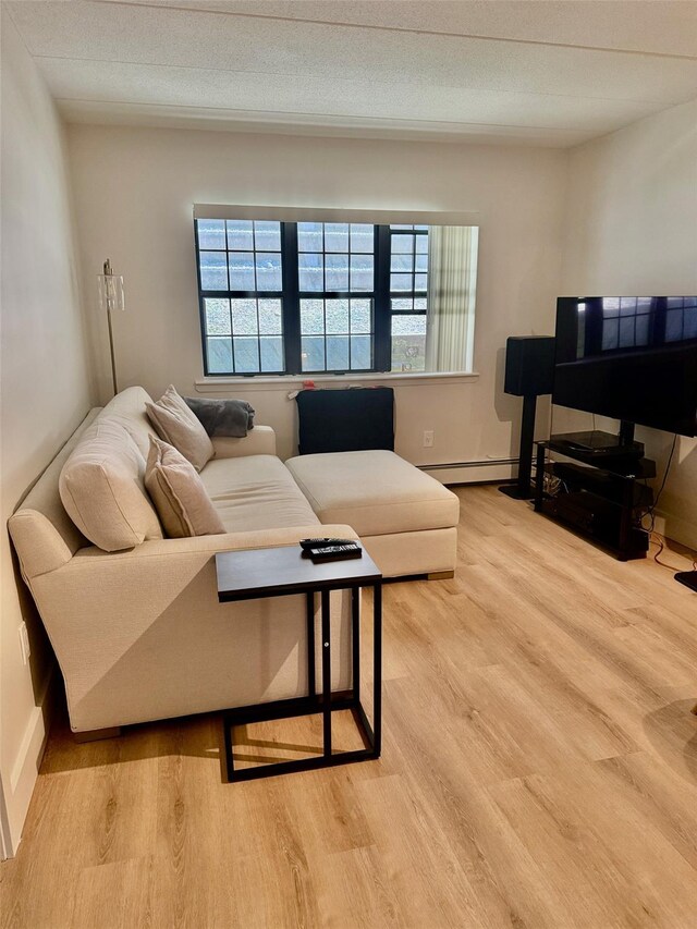 living room featuring baseboard heating and light wood-style flooring