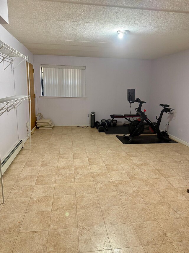 workout room with baseboard heating and a textured ceiling