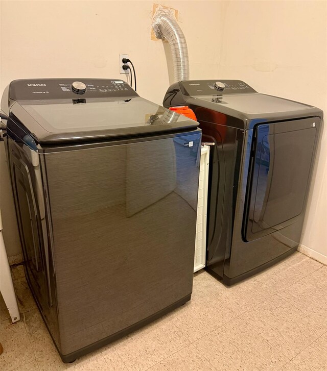 laundry room with washing machine and clothes dryer and laundry area
