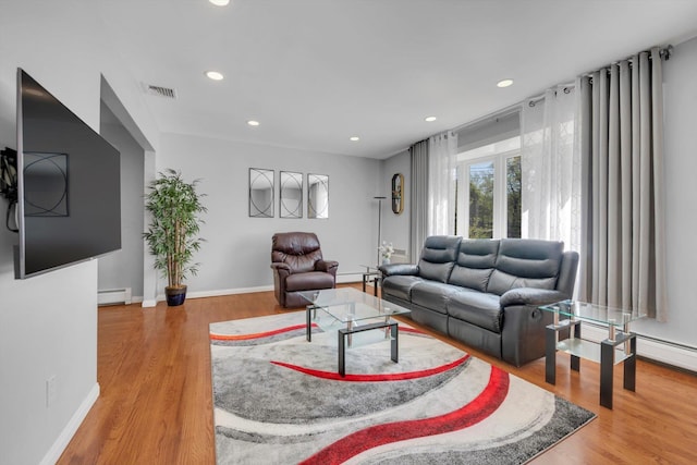 143-07 Rose Ave, Flushing, NY 11355 - living area featuring a baseboard radiator, wood finished floors, recessed lighting, baseboards, and a baseboard heating unit