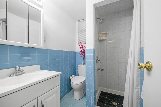 143-07 Rose Ave, Flushing, NY 11355 - full bath with toilet, vanity, tile walls, a tile shower, and a wainscoted wall