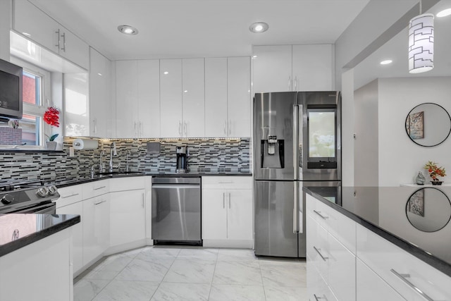 143-07 Rose Ave, Flushing, NY 11355 - kitchen with appliances with stainless steel finishes, light marble finish floors, white cabinetry, and recessed lighting