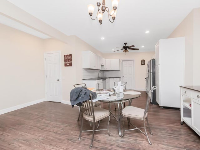 dining area featuring dark wood-style floors, baseboards, ceiling fan with notable chandelier, and recessed lighting