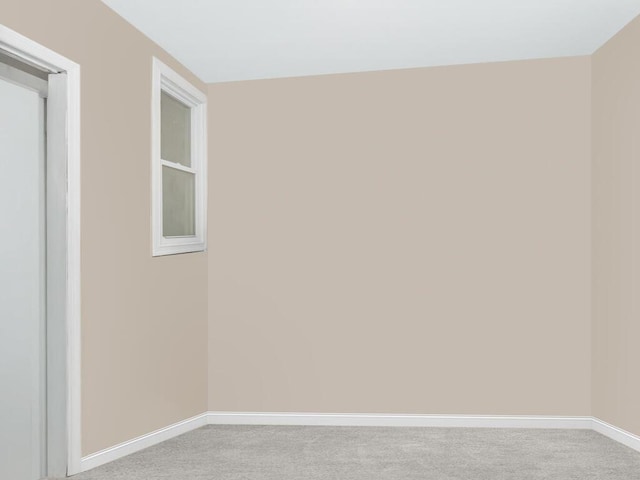 empty room with light colored carpet and baseboards