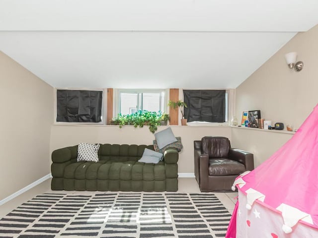 living area featuring baseboards
