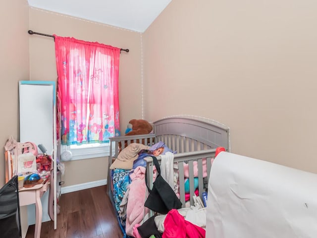 bedroom with wood finished floors and baseboards