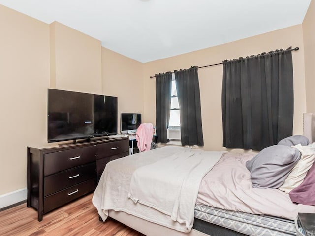 bedroom featuring light wood-style flooring and baseboards