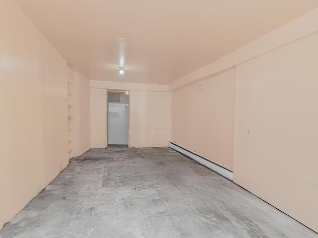 empty room with concrete flooring and baseboard heating