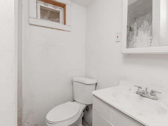 bathroom featuring toilet and vanity