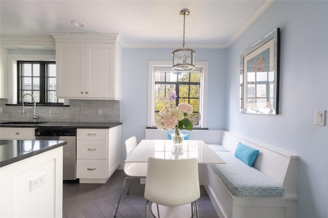 dining room featuring a wealth of natural light and crown molding