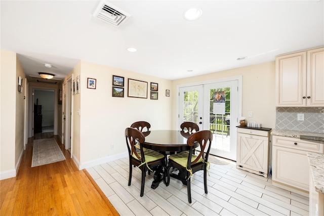 dining room featuring french doors, light wood-type flooring, visible vents, baseboards, and recessed lighting