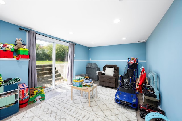 recreation room with visible vents, wood finished floors, and recessed lighting