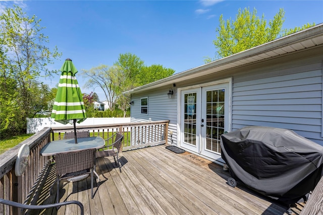 deck featuring area for grilling, outdoor dining area, and french doors