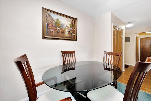 dining room with baseboards and wood finished floors