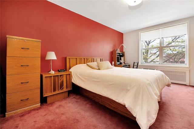 bedroom featuring radiator, carpet floors, and lofted ceiling