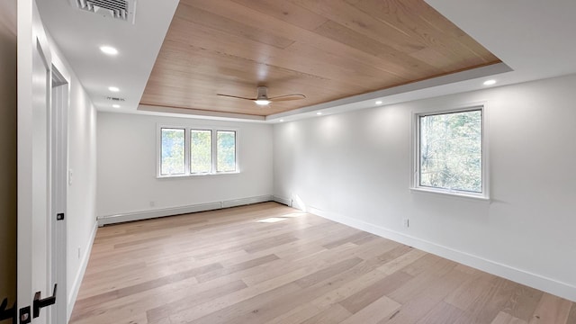 empty room featuring wood ceiling, a raised ceiling, visible vents, a baseboard heating unit, and a ceiling fan