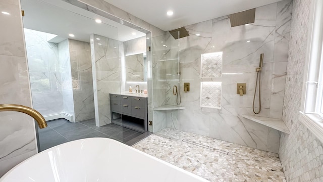 bathroom featuring a soaking tub, a marble finish shower, recessed lighting, tile walls, and vanity