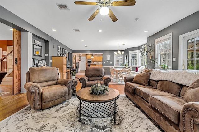 living area featuring light wood-style floors, plenty of natural light, visible vents, and recessed lighting