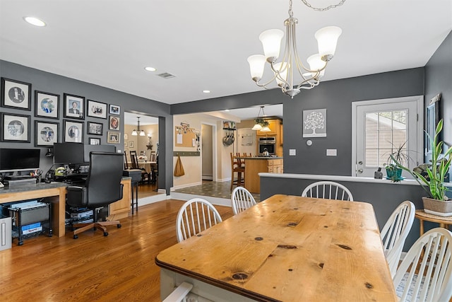 dining room featuring recessed lighting, an inviting chandelier, visible vents, baseboards, and wood finished floors